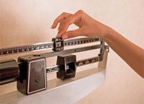 person measuring weight on a scale