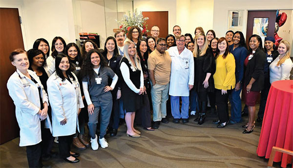Members of the RWJBarnabas Health transplant team gather with Ronald Kishun and Sheila Devaney to celebrate the kidney transplant that changed Ronald’s life.