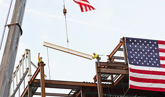 Crew members place beam