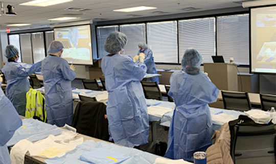 Nurses participating in a training for central line catheter insertion