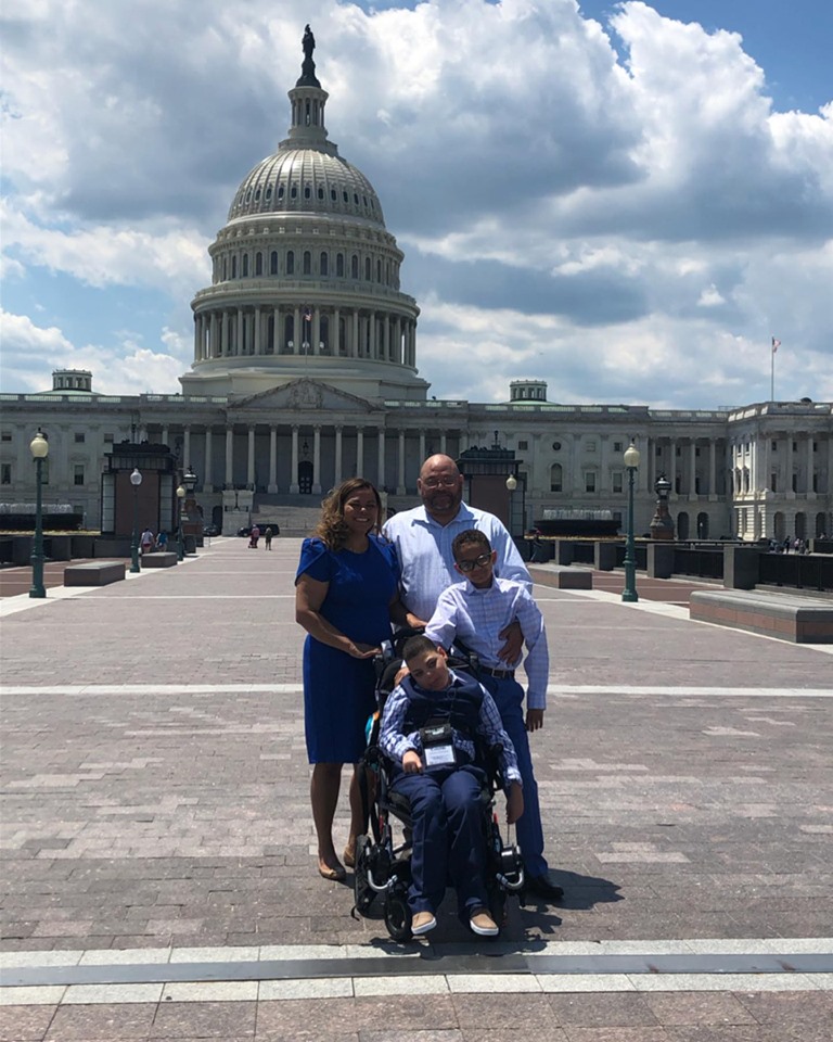 family in front of a building