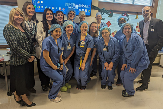 Monmouth Medical Center Lotus Award honoree Pamela Molina is shown with her OR teammates and hospital leadership.