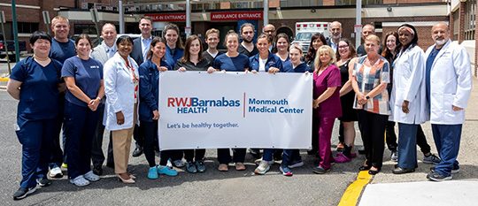 Hospital leadership gather with MMC Emergency Department staff members.