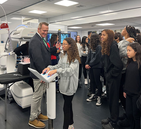 Thoracic surgeon Dr. Joseph Whitlark instructs Long Branch Middle School students on the operation of the Ion robot