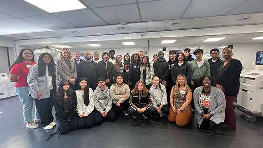 Students from Long Branch High School gather inside the TOME Truck