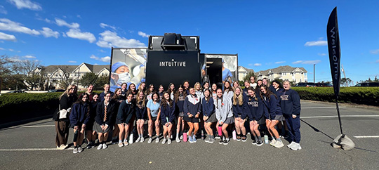 Students from Trinity Hall gather outside the TOME Truck