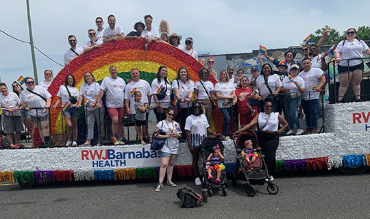RWJBarnabas Health float at the Asbury Park Pride parade - 150 employees standing on and around the float featuring a rainbow
