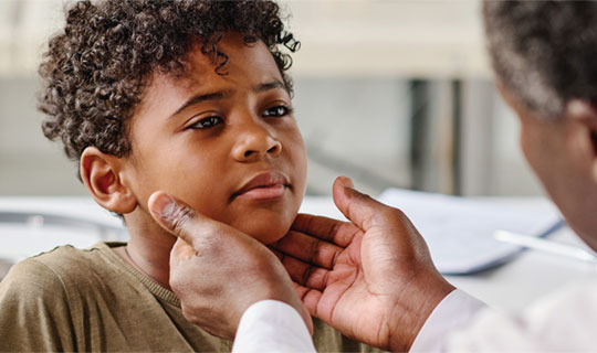 doctor examining a child's throat