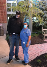 New York Giant Rasheed Simmons, owner of the Belmar restaurant Simply Southern (shown with MMC patient care associate Cristina Navarro) donated 100 meals