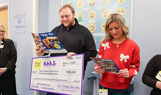 Tom Aquilino, Spirit of Children holding the donation check