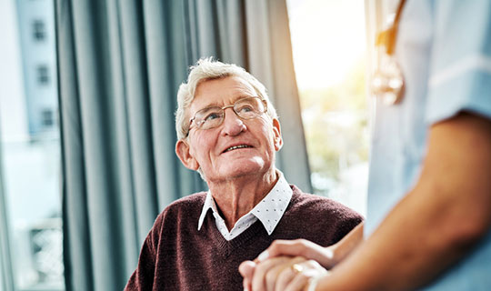 senior man talking with caregiver