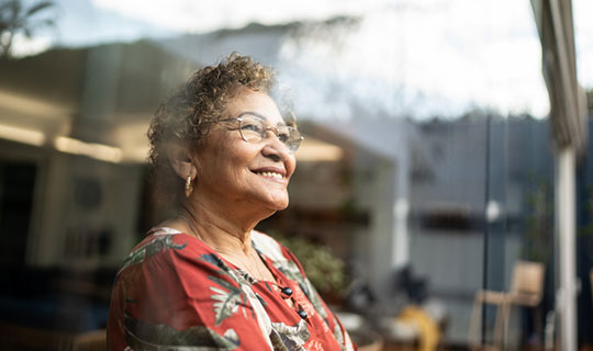 Senior woman looking out the window