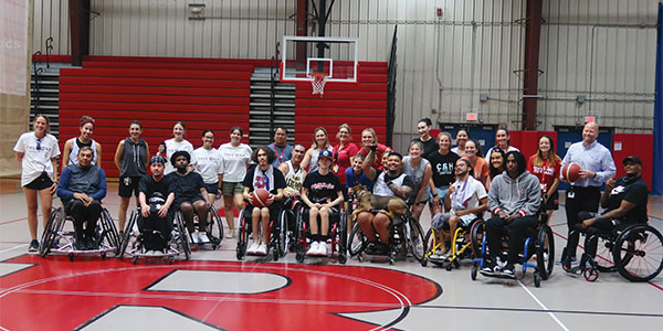 large group of teens gathered in the gym - some in wheelchairs and some standing