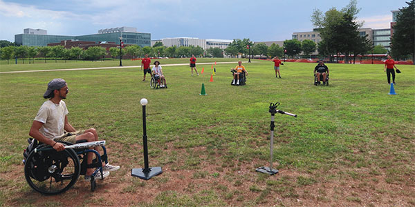 Isaac playing wheelchair whiffle ball